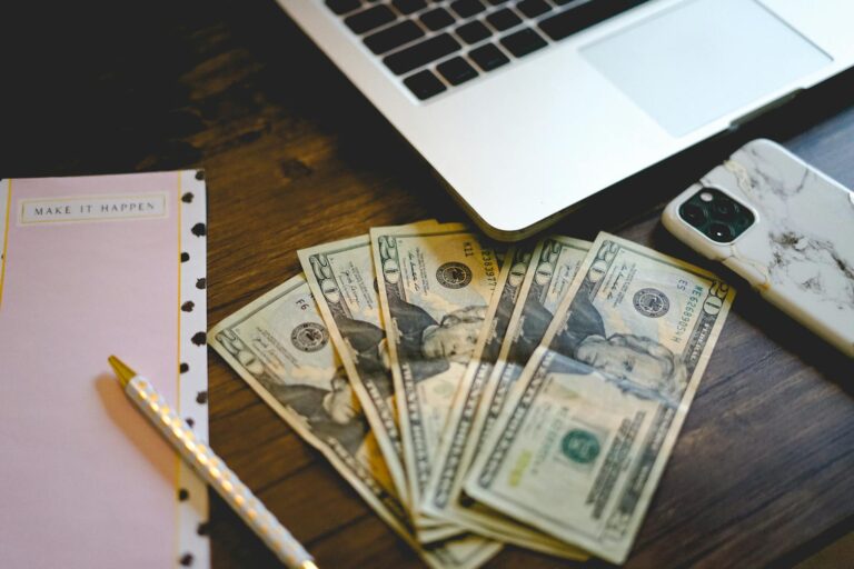 twenty dollar bills on top of a wooden desk